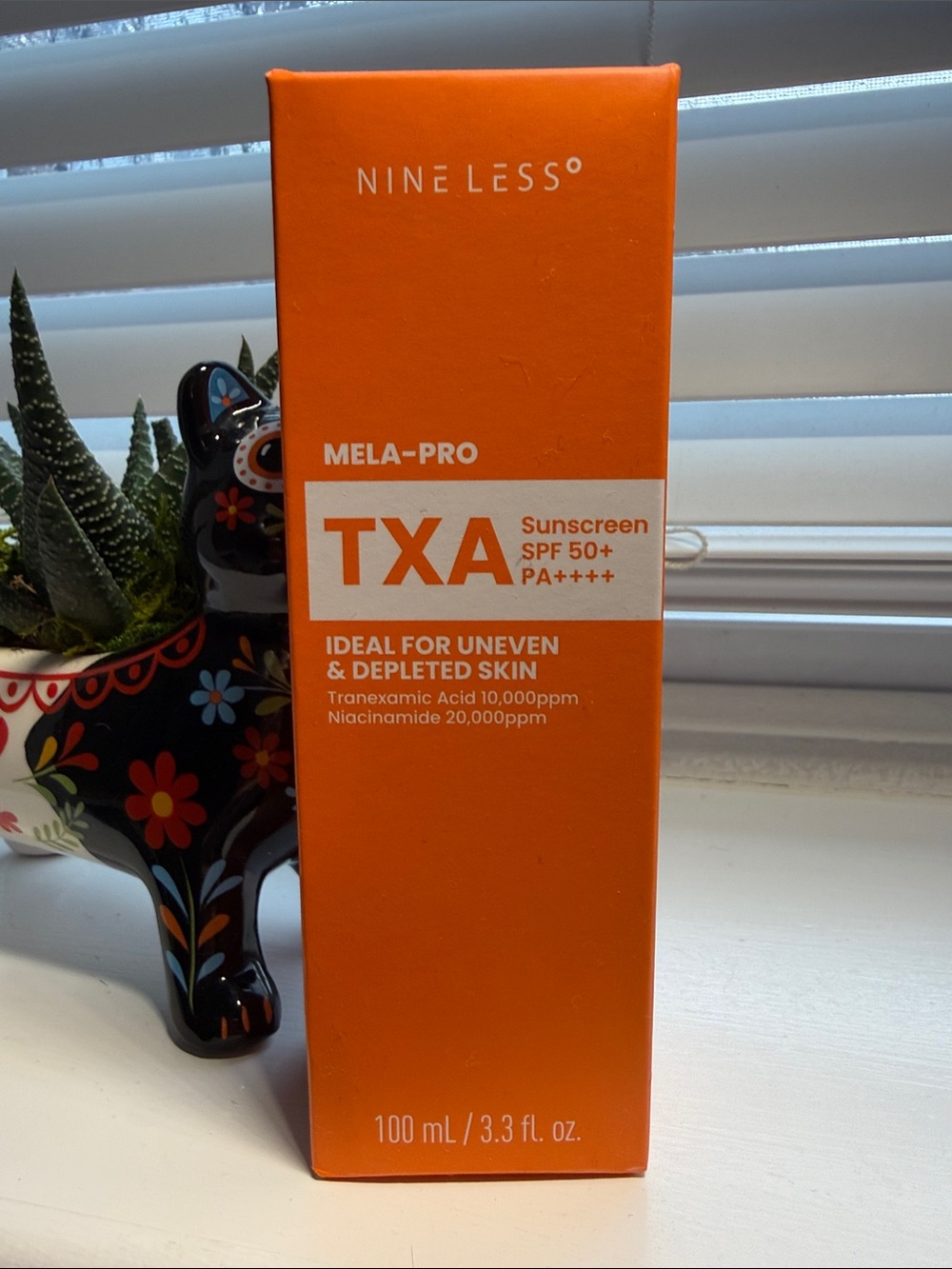 NINELESS Mela-Pro TXA Sunscreen SPF 50+ - Bright Orange Box